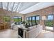 Inviting living room with stylish furnishings, brick accents, and large windows offering scenic views of the surrounding landscape at 1140 Lake Gulch Rd, Castle Rock, CO 80104