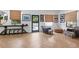 Bright living room with herringbone floors, stylish decor, and door that leads to outdoor patio at 1140 Lake Gulch Rd, Castle Rock, CO 80104
