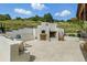 Inviting outdoor space featuring a fireplace, built-in seating, and picturesque views of the surrounding landscape at 1140 Lake Gulch Rd, Castle Rock, CO 80104