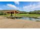Picturesque pond with a cabana and chairs offering a tranquil spot to unwind and enjoy the scenery at 1140 Lake Gulch Rd, Castle Rock, CO 80104