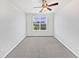 Empty bedroom with ceiling fan, carpet, and a window with bright, natural light at 4100 Albion St # 523, Denver, CO 80216