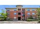 Attractive brick apartment building with mature trees and manicured landscaping at 4100 Albion St # 523, Denver, CO 80216