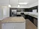 Modern kitchen with stainless steel appliances and a large granite island at 4100 Albion St # 523, Denver, CO 80216