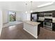 Open-concept kitchen with island and stainless steel appliances connecting to the living area at 4100 Albion St # 523, Denver, CO 80216