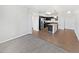 Open-concept living area with hardwood floors seamlessly connects to the modern kitchen at 4100 Albion St # 523, Denver, CO 80216