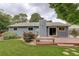 Backyard with a wooden deck, a bench, mature trees and a lush green lawn at 10883 Otis Cir, Westminster, CO 80020