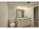 Bright bathroom featuring double sinks, ample counter space, and a large mirror at 10883 Otis Cir, Westminster, CO 80020