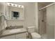 Clean bathroom with a shower, white vanity, and well-lit mirror at 10883 Otis Cir, Westminster, CO 80020