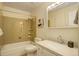 Clean bathroom featuring a shower-tub combo, vanity, and a well-lit mirror at 10883 Otis Cir, Westminster, CO 80020