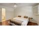 Comfortable bedroom featuring a queen bed and bedside table; view to bathroom through doorway at 10883 Otis Cir, Westminster, CO 80020