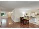 Open floor plan with a dining area, adjacent kitchen and attractive wood-look flooring at 10883 Otis Cir, Westminster, CO 80020