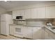 Well-lit kitchen boasts white cabinetry, modern appliances, and a clean, functional design at 10883 Otis Cir, Westminster, CO 80020