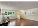 Bright living room features wood-look floors, a large window and neutral decor at 10883 Otis Cir, Westminster, CO 80020