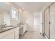 Bathroom featuring double sinks, grey countertops, and a glass-enclosed shower at 5578 Inland Ave, Firestone, CO 80504