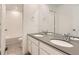 Bathroom with double vanity, grey countertops, and a separate shower and bathtub at 5578 Inland Ave, Firestone, CO 80504