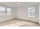 Cozy bedroom with carpet, white walls, and natural light from the surrounding windows at 5578 Inland Ave, Firestone, CO 80504