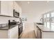 Open concept kitchen featuring stainless steel appliances, island sink, and ample counter space at 5578 Inland Ave, Firestone, CO 80504