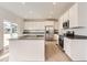Modern kitchen with white cabinets, stainless steel appliances, and a center island at 5578 Inland Ave, Firestone, CO 80504
