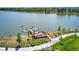 Aerial view of the lake featuring a dock, paddleboards, picnic tables, and sidewalks at 5578 Inland Ave, Firestone, CO 80504