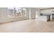 Bright and airy living room featuring hardwood floors and multiple windows for natural light at 5578 Inland Ave, Firestone, CO 80504