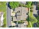 Aerial view of the home highlighting its roof, driveway, and landscaped surroundings at 7664 S Ivanhoe Way, Centennial, CO 80112