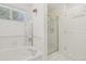 Bathroom featuring a bathtub and shower with tiled walls at 7664 S Ivanhoe Way, Centennial, CO 80112