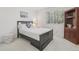 Bedroom with a large window and comfortable bed, plus dark wood bookcase at 7664 S Ivanhoe Way, Centennial, CO 80112