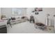Bright bonus room featuring a comfortable couch, decorative artwork, and workout trampoline at 7664 S Ivanhoe Way, Centennial, CO 80112