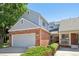 Charming home featuring a brick facade, attached garage, and well-kept front yard at 7664 S Ivanhoe Way, Centennial, CO 80112