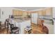 Eat-in kitchen with bar seating, tiled floors and white appliances at 7664 S Ivanhoe Way, Centennial, CO 80112