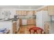 Efficient kitchen with tiled backsplash, tiled floors and white appliances at 7664 S Ivanhoe Way, Centennial, CO 80112