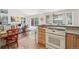 Bright eat-in kitchen with bar seating, stainless appliances, and slider to patio at 7664 S Ivanhoe Way, Centennial, CO 80112