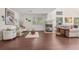 Bright living room features hardwood floors, large windows, and a cozy fireplace at 7664 S Ivanhoe Way, Centennial, CO 80112