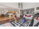 Open-concept living room and kitchen with hardwood floors, comfortable seating, and plenty of natural light at 7664 S Ivanhoe Way, Centennial, CO 80112