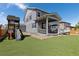 Exterior view of home and backyard play structure with artificial turf at 1315 Sidewinder Cir, Castle Rock, CO 80108