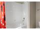 Tiled bathtub/shower combination, enclosed with a Mickey Mouse themed shower curtain at 1315 Sidewinder Cir, Castle Rock, CO 80108