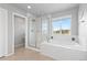 Bright bathroom with a standalone tub, a window and a glass enclosed shower at 1315 Sidewinder Cir, Castle Rock, CO 80108