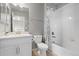 Bright bathroom with a single vanity and white tile tub/shower at 1315 Sidewinder Cir, Castle Rock, CO 80108