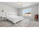 Cozy bedroom with large window allowing natural light and neutral carpeting at 1315 Sidewinder Cir, Castle Rock, CO 80108