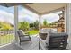 Inviting covered patio featuring a stone fire pit, comfortable seating, and a lush backyard at 1315 Sidewinder Cir, Castle Rock, CO 80108