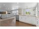 Bright kitchen with white cabinets, stainless steel appliances, and an open floor plan at 1315 Sidewinder Cir, Castle Rock, CO 80108