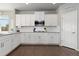 Modern kitchen with white cabinets, stainless steel appliances, and hardwood floors at 1315 Sidewinder Cir, Castle Rock, CO 80108