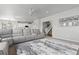 Spacious living room featuring a large gray sectional, open to the kitchen and staircase at 1315 Sidewinder Cir, Castle Rock, CO 80108