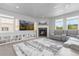 Bright living room featuring a fireplace, built-in shelving, and a plush gray sectional at 1315 Sidewinder Cir, Castle Rock, CO 80108