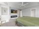 Spacious main bedroom featuring a fireplace, TV, and tray ceiling with a modern ceiling fan at 1315 Sidewinder Cir, Castle Rock, CO 80108