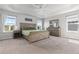 Spacious main bedroom with a tray ceiling, carpeting, and natural light from the windows at 1315 Sidewinder Cir, Castle Rock, CO 80108