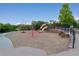 Community playground featuring climbing structures, slides, and soft gravel ground, surrounded by greenery at 1315 Sidewinder Cir, Castle Rock, CO 80108