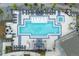 Aerial shot of a modern geometric pool design with lounge chairs, jacuzzi and a fireplace seating area at 1315 Sidewinder Cir, Castle Rock, CO 80108