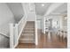 Open staircase with carpeted steps and white railings leading to the upper level at 1315 Sidewinder Cir, Castle Rock, CO 80108