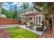Inviting backyard patio with a pergola, outdoor seating, string lights, and a landscaped yard at 3322 W 26Th Ave, Denver, CO 80211